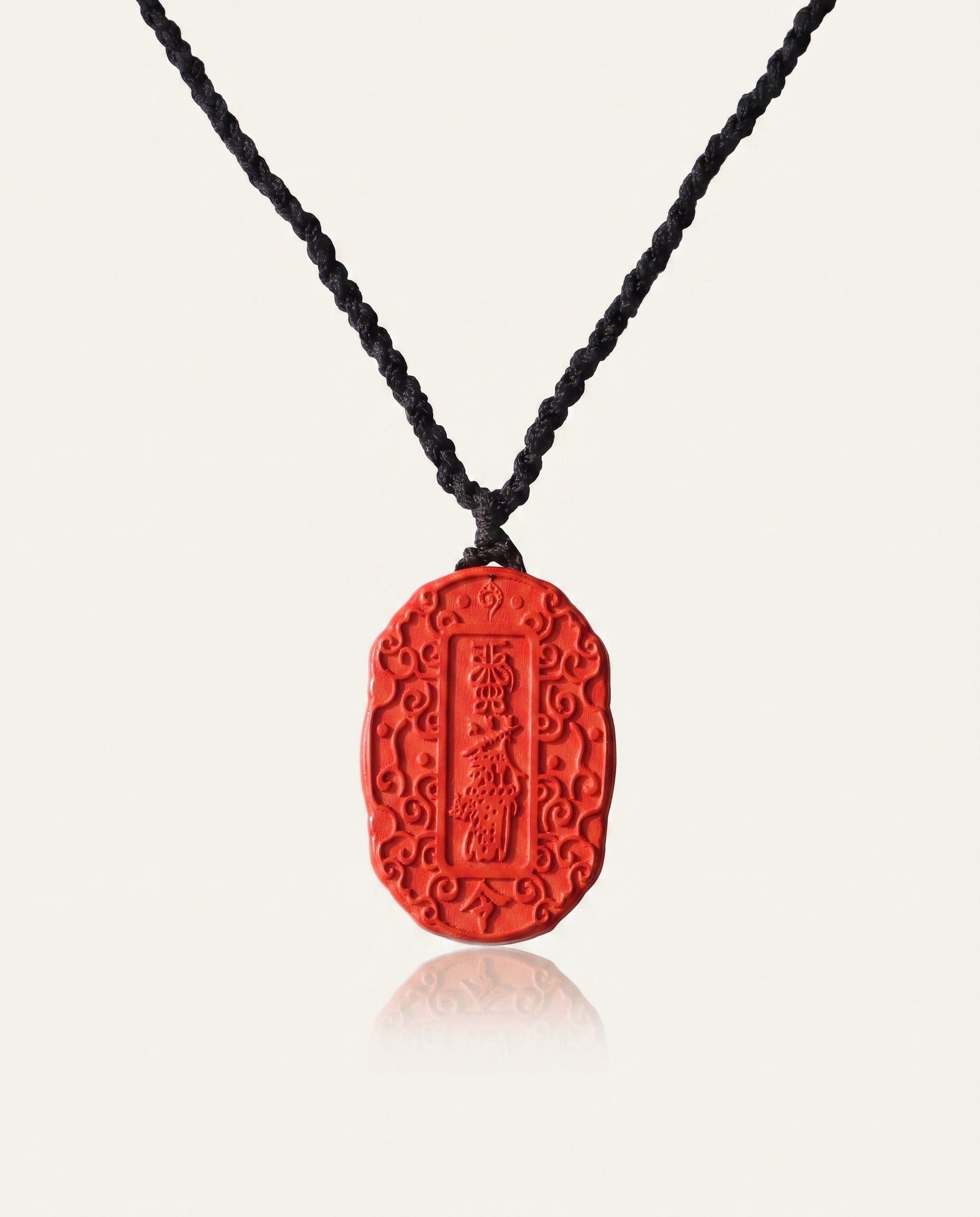 Auspicious Talisman cinnabar necklace on ivory studio background