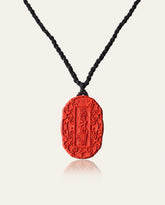 Auspicious Talisman cinnabar necklace on ivory studio background