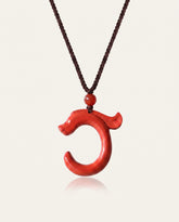 Dragon Hook cinnabar necklace on ivory studio background
