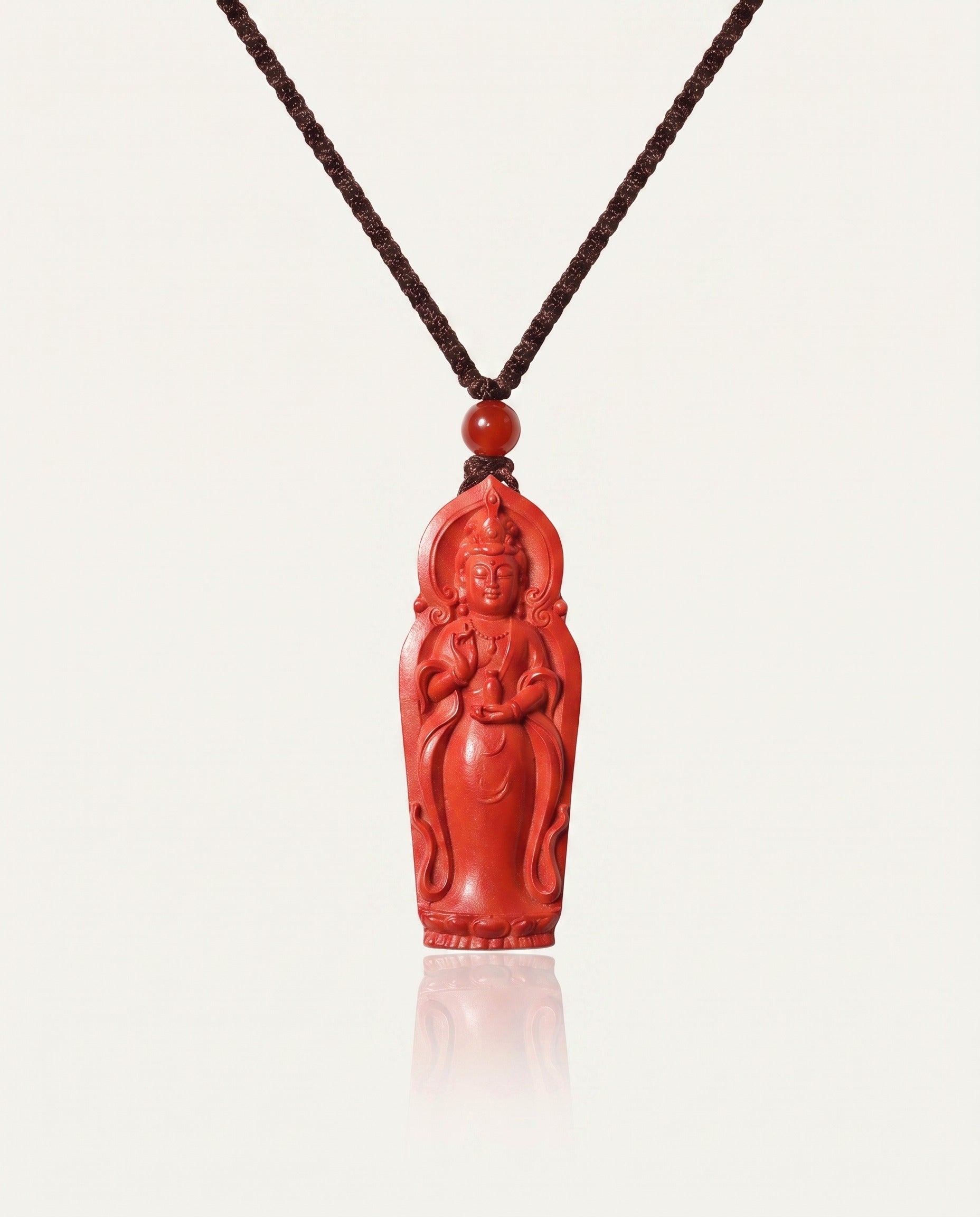 Guan Yin cinnabar necklace on ivory studio background