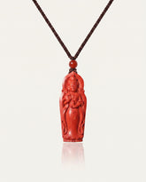 Guan Yin cinnabar necklace on ivory studio background