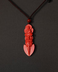 Guan Yin Phurba cinnabar necklace on dark background