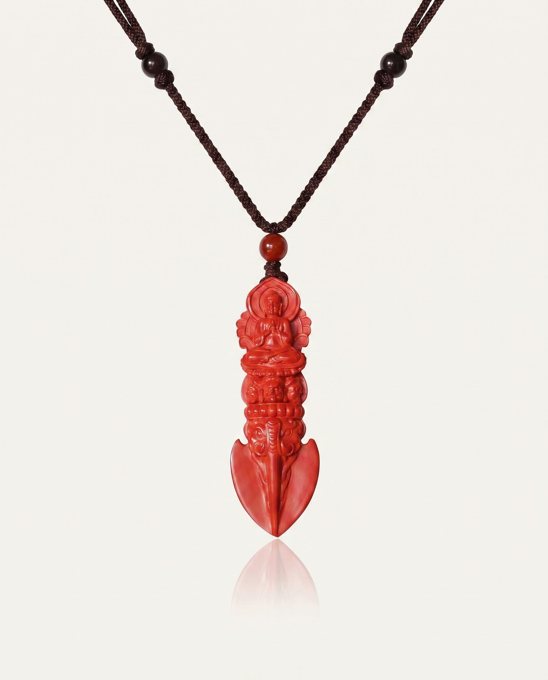 Guan Yin Phurba cinnabar necklace on ivory studio background