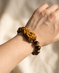 Carved Pixiu Dragon Tiger Eye Bracelet worn on wrist