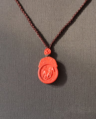 Horse Guardian cinnabar necklace on dark background