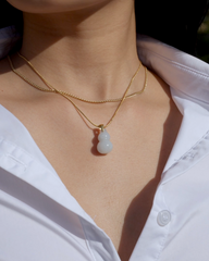 Jade hulu gourd necklace worn by model