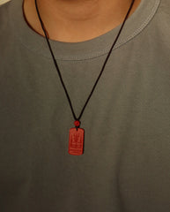 Mantra Protection Amulet cinnabar necklace on dark background