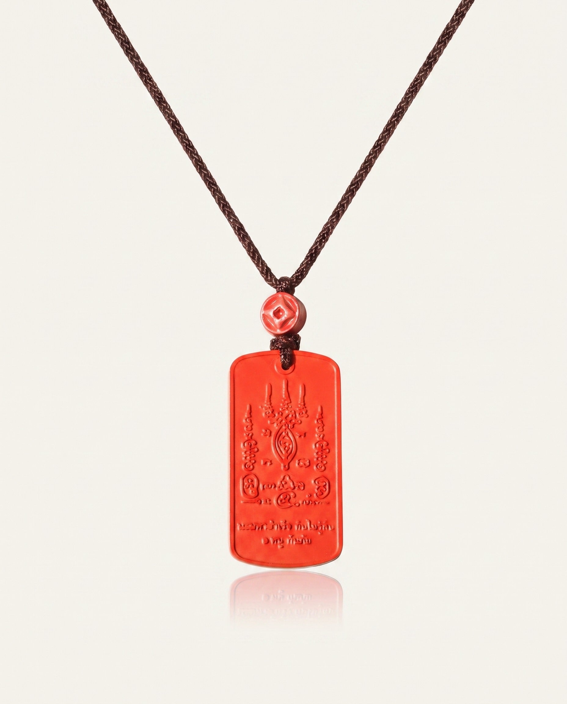 Mantra Protection Amulet cinnabar necklace on ivory studio background