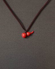 Mini Hulu cinnabar necklace on dark background