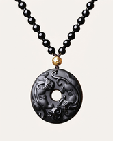 Twin Pixiu obsidian pendant necklace on ivory studio background