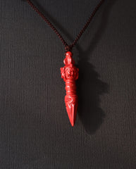 Phurba cinnabar necklace on dark background