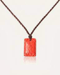 Ping An cinnabar necklace on ivory studio background
