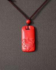 Pixiu Tag cinnabar necklace on dark background