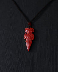 Protection Arrow cinnabar necklace on dark background