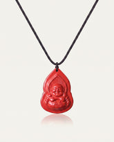Seated Laughing Buddha cinnabar necklace on ivory studio background