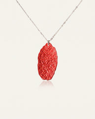 Six Character Mantra cinnabar necklace on silver chain, ivory studio background