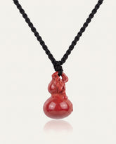 Smooth Hulu cinnabar necklace on ivory studio background
