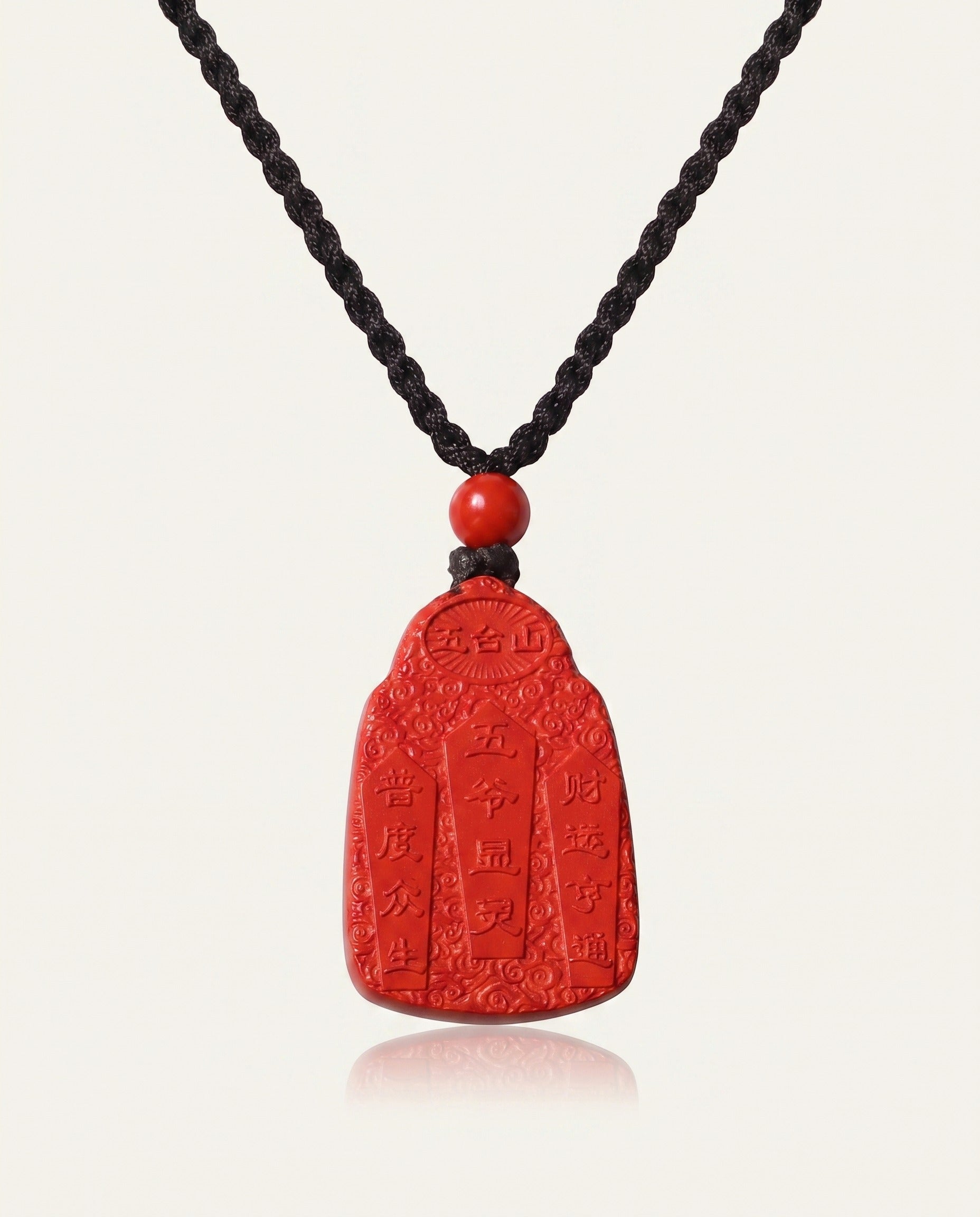 Wealth God cinnabar necklace on ivory studio background