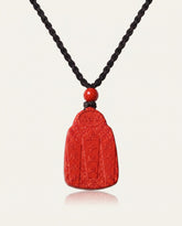Wealth God cinnabar necklace on ivory studio background