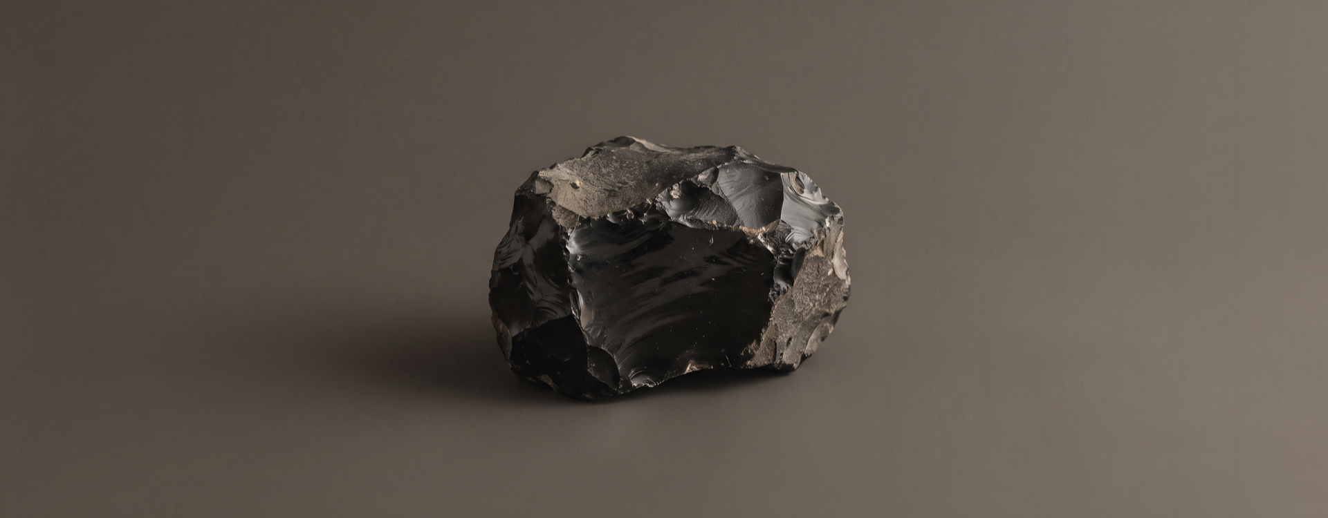 Obsidian collection — raw obsidian on warm charcoal