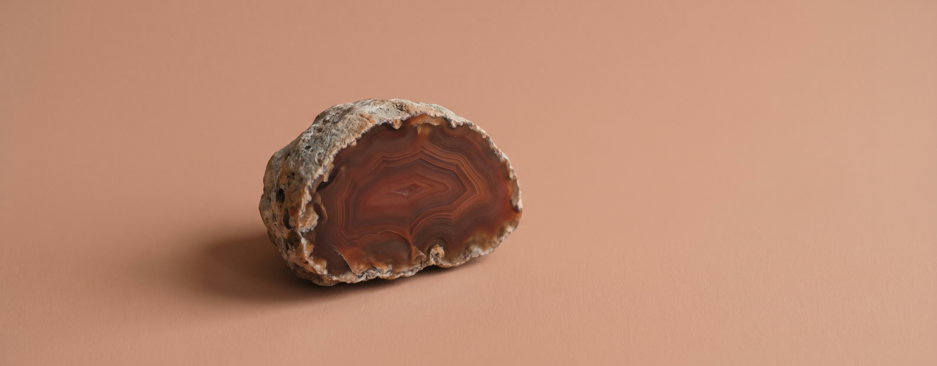 Red Agate collection — agate geode on pale terracotta