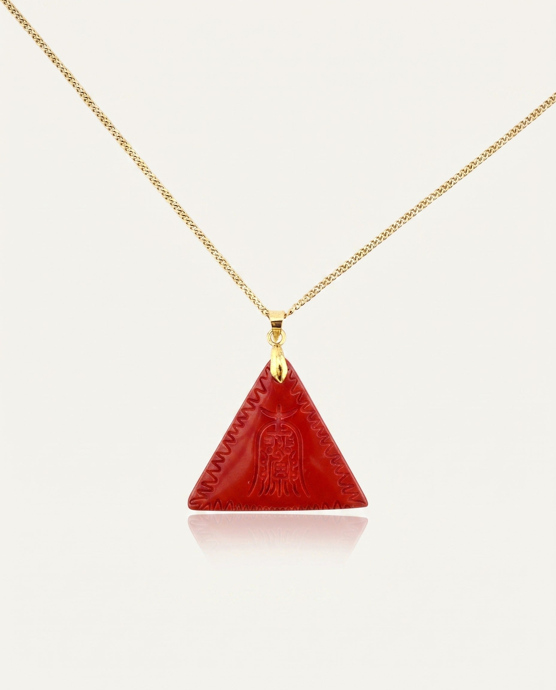 Amitabha Triangle cinnabar necklace on gold chain, ivory studio background