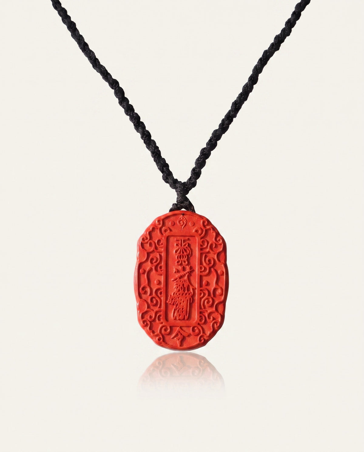 Auspicious Talisman cinnabar necklace on ivory studio background