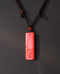 Buddha Pillar cinnabar necklace on dark background