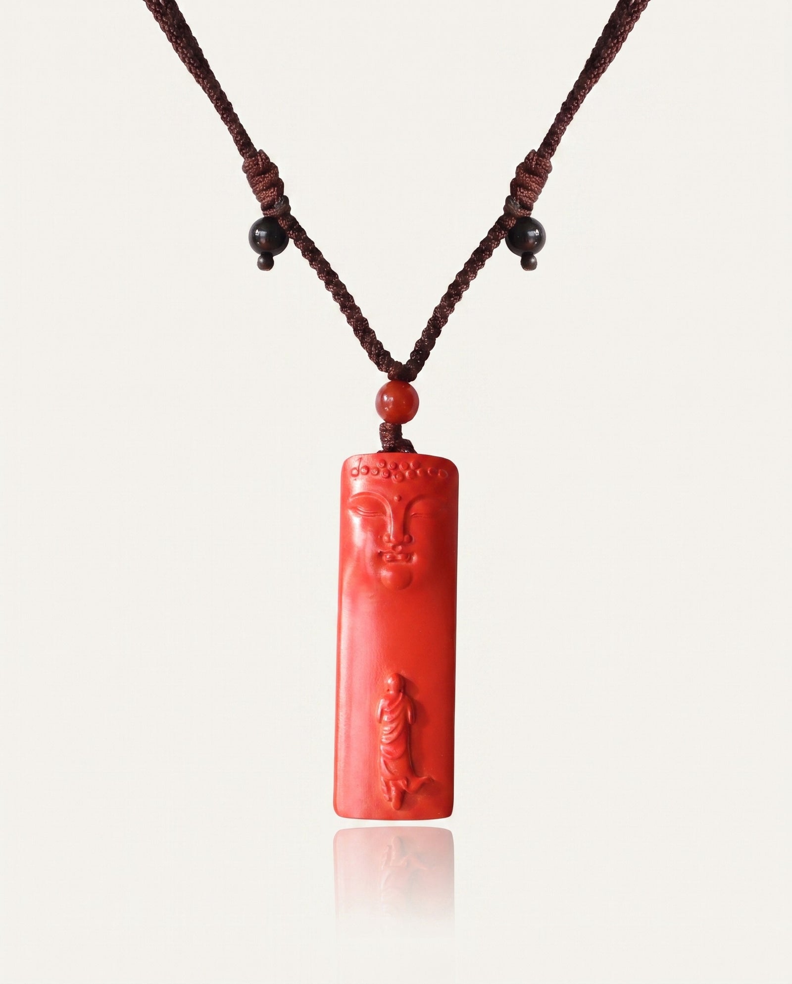 Buddha Pillar cinnabar necklace on ivory studio background