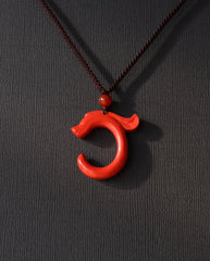 Dragon Hook cinnabar necklace on dark background