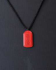 Dragon Yin Yang Talisman cinnabar necklace on dark background