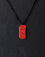 Dragon Yin Yang Talisman cinnabar necklace on dark background