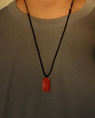 Dragon Yin Yang Talisman cinnabar necklace on dark background