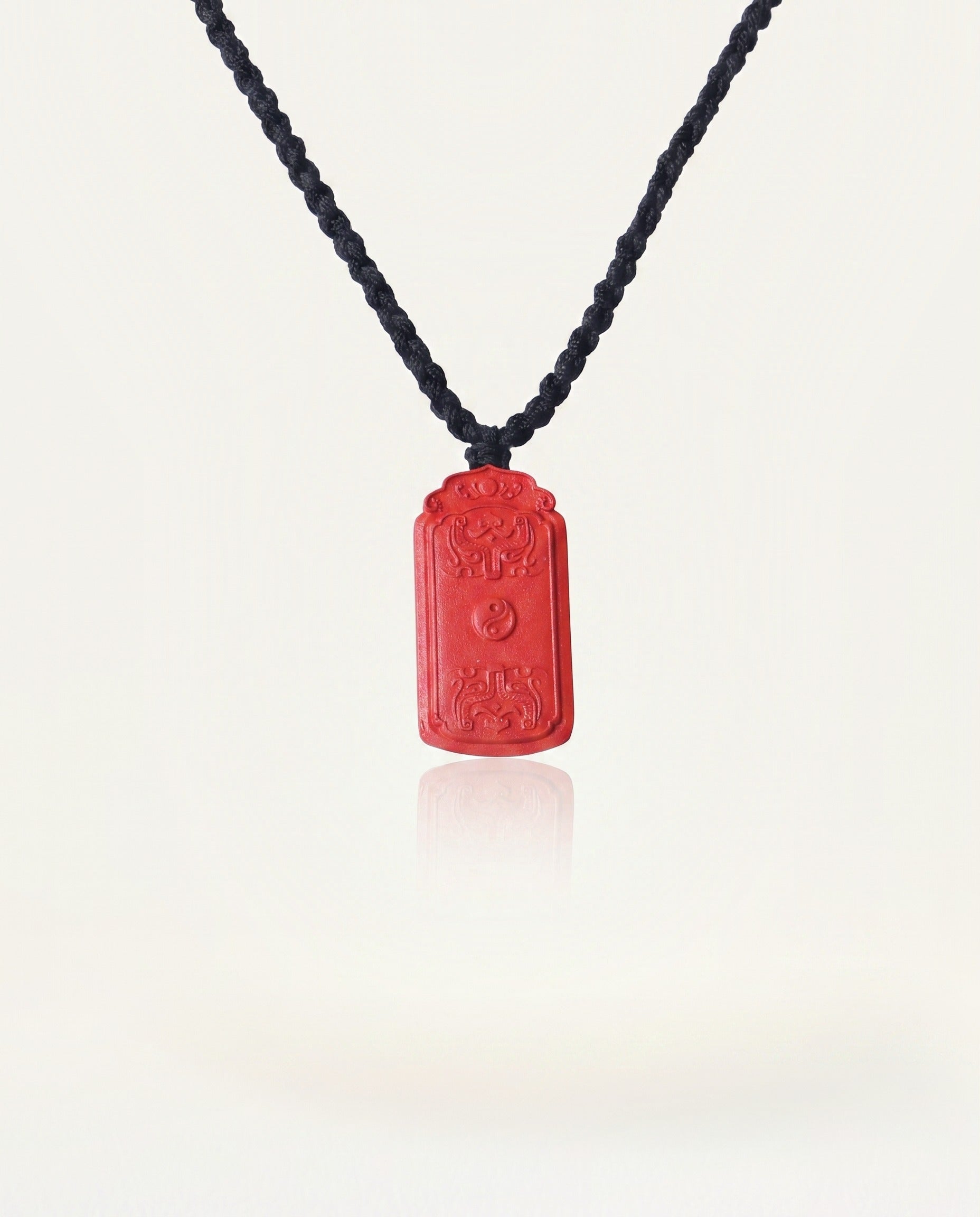 Dragon Yin Yang Talisman cinnabar necklace on ivory studio background