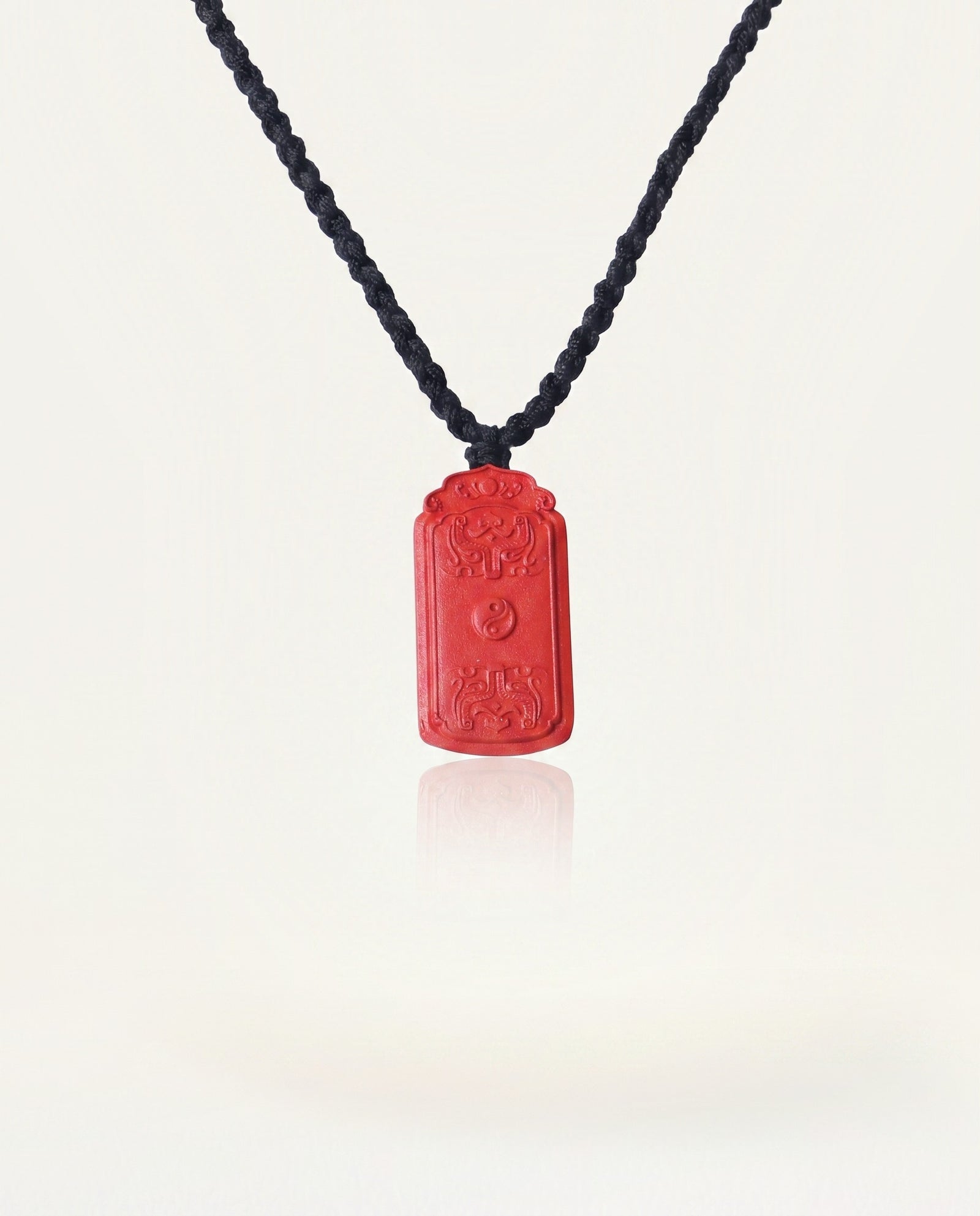 Dragon Yin Yang Talisman cinnabar necklace on ivory studio background