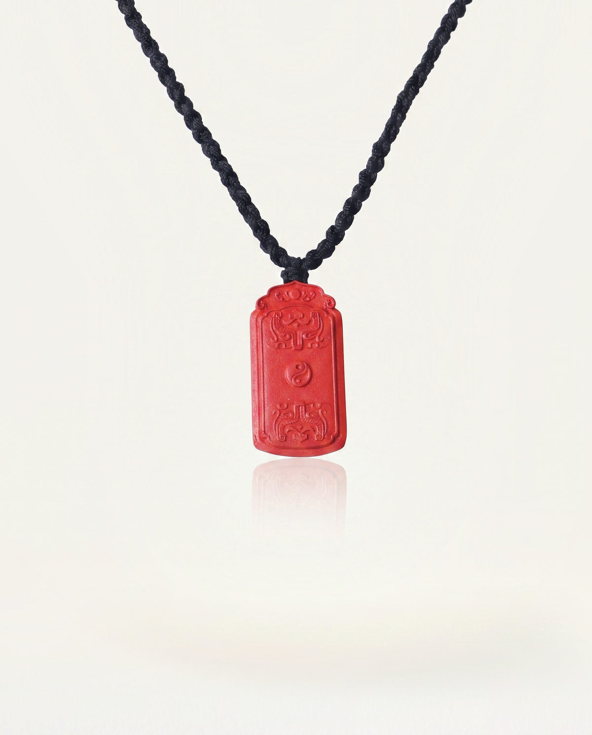 Dragon Yin Yang Talisman cinnabar necklace on ivory studio background