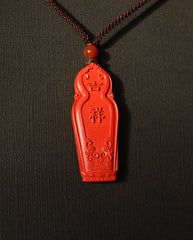 Guan Yin cinnabar necklace on dark background