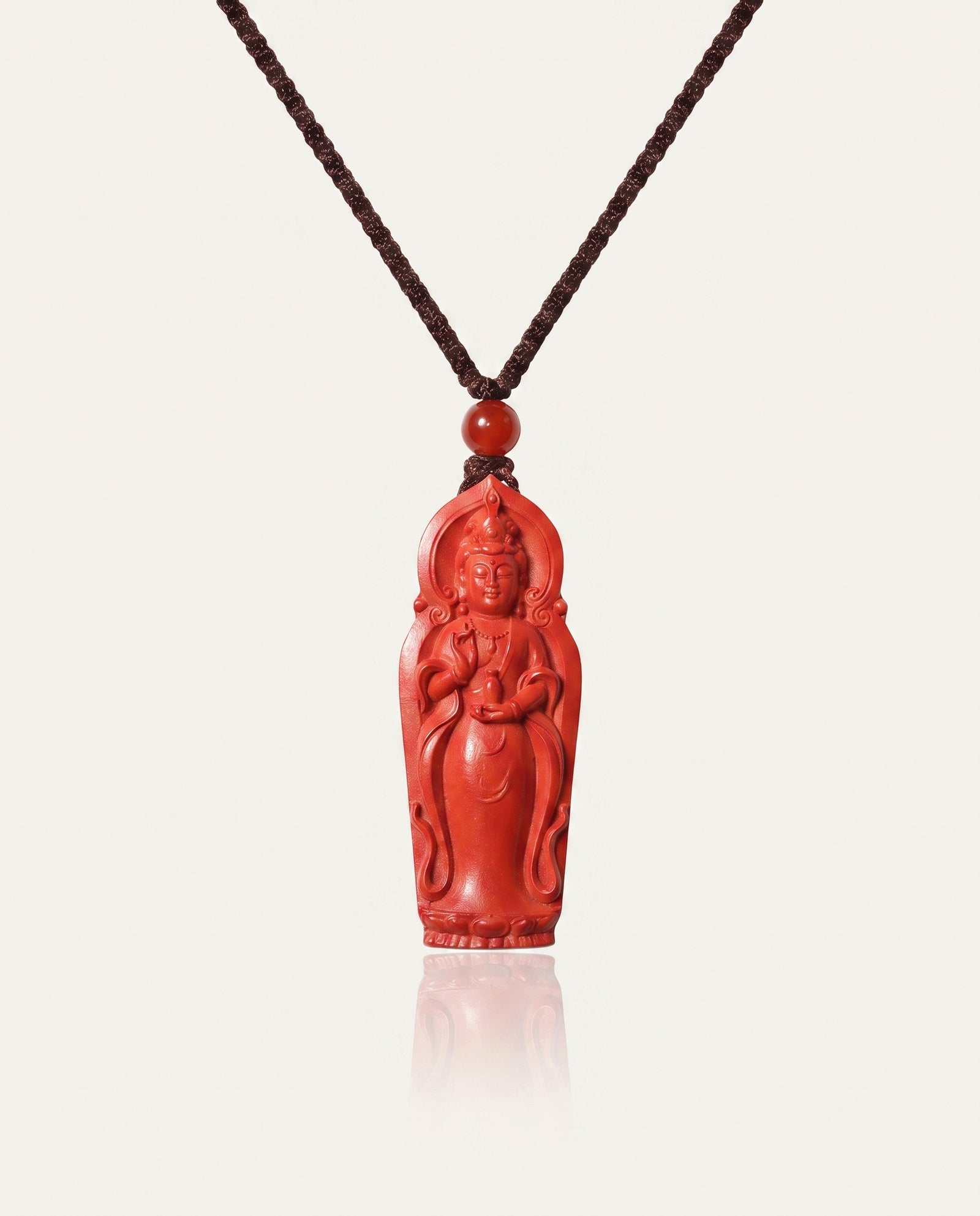 Guan Yin cinnabar necklace on ivory studio background