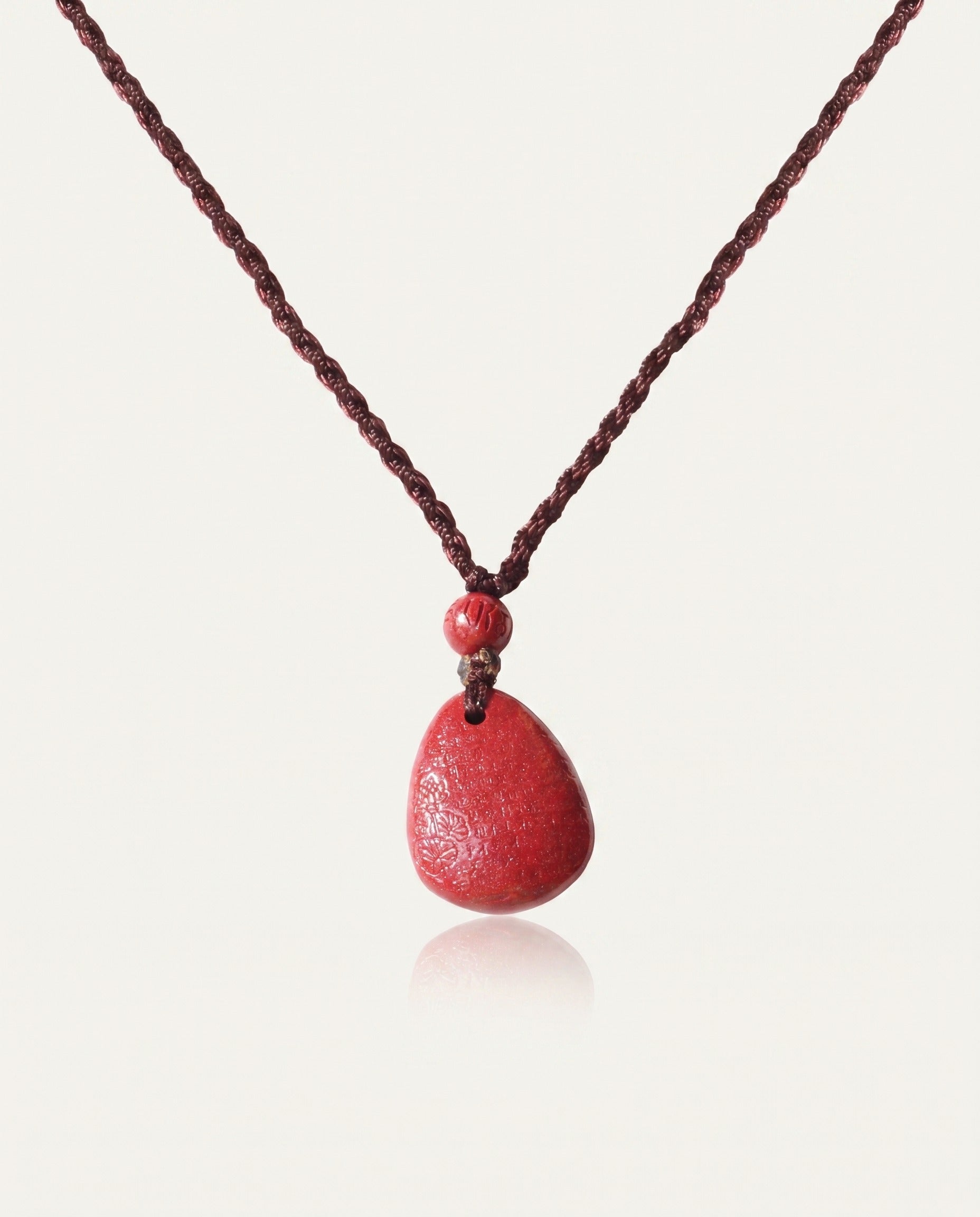 Heart Sutra Teardrop cinnabar necklace back on ivory studio background