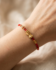 Pixiu Dragon with Lucky Coin Red String Bracelet worn on wrist