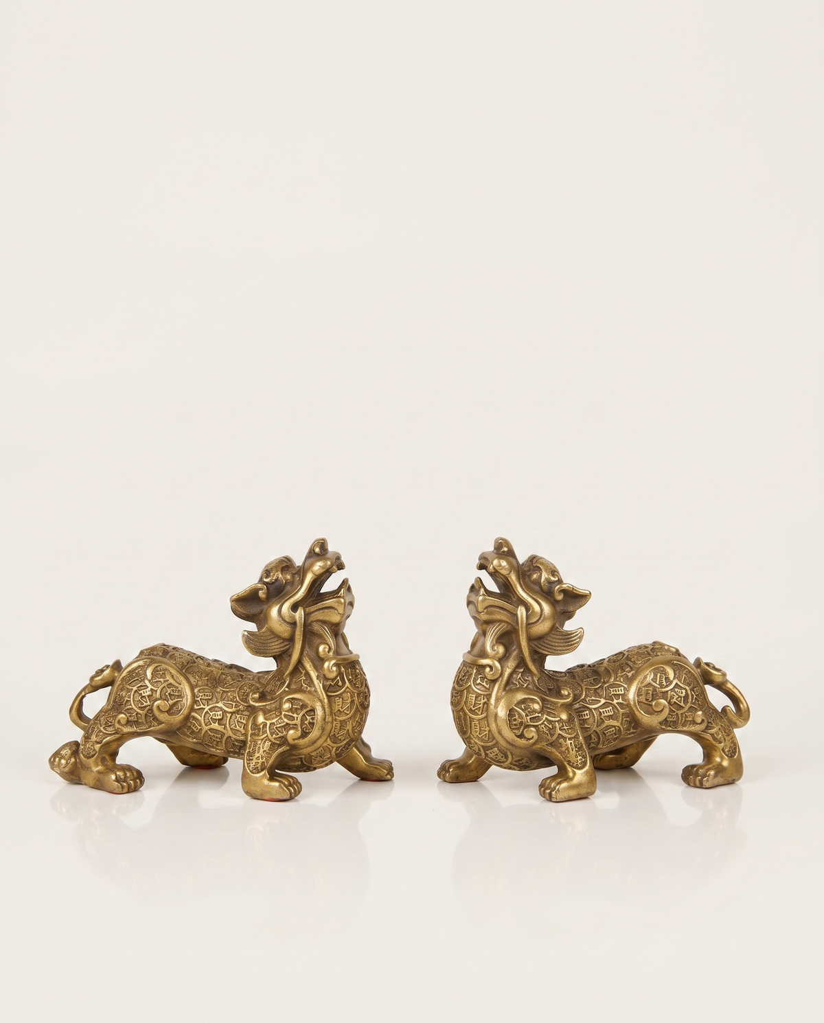 brass pixiu covered in coins pair