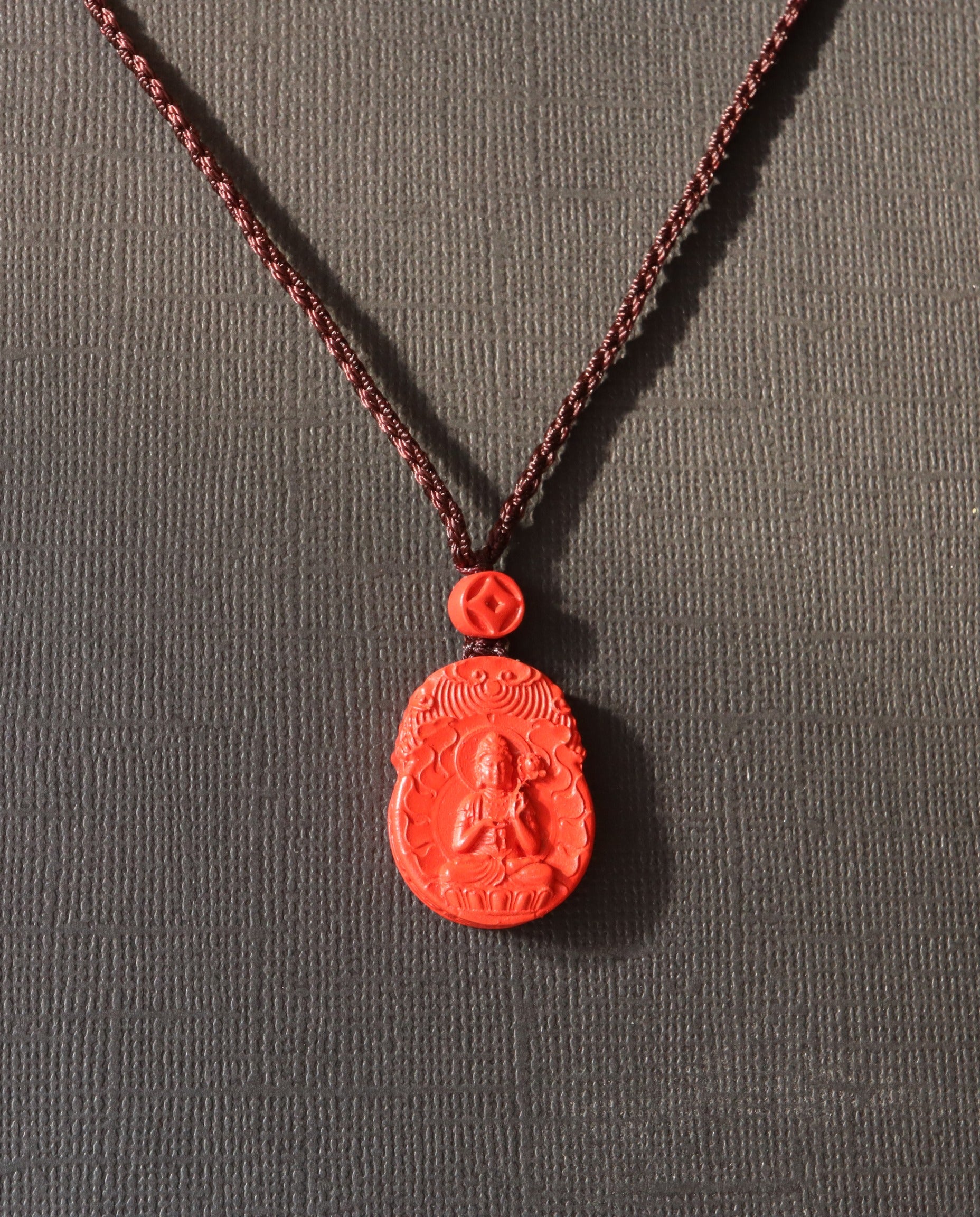 Horse Guardian cinnabar necklace on dark background