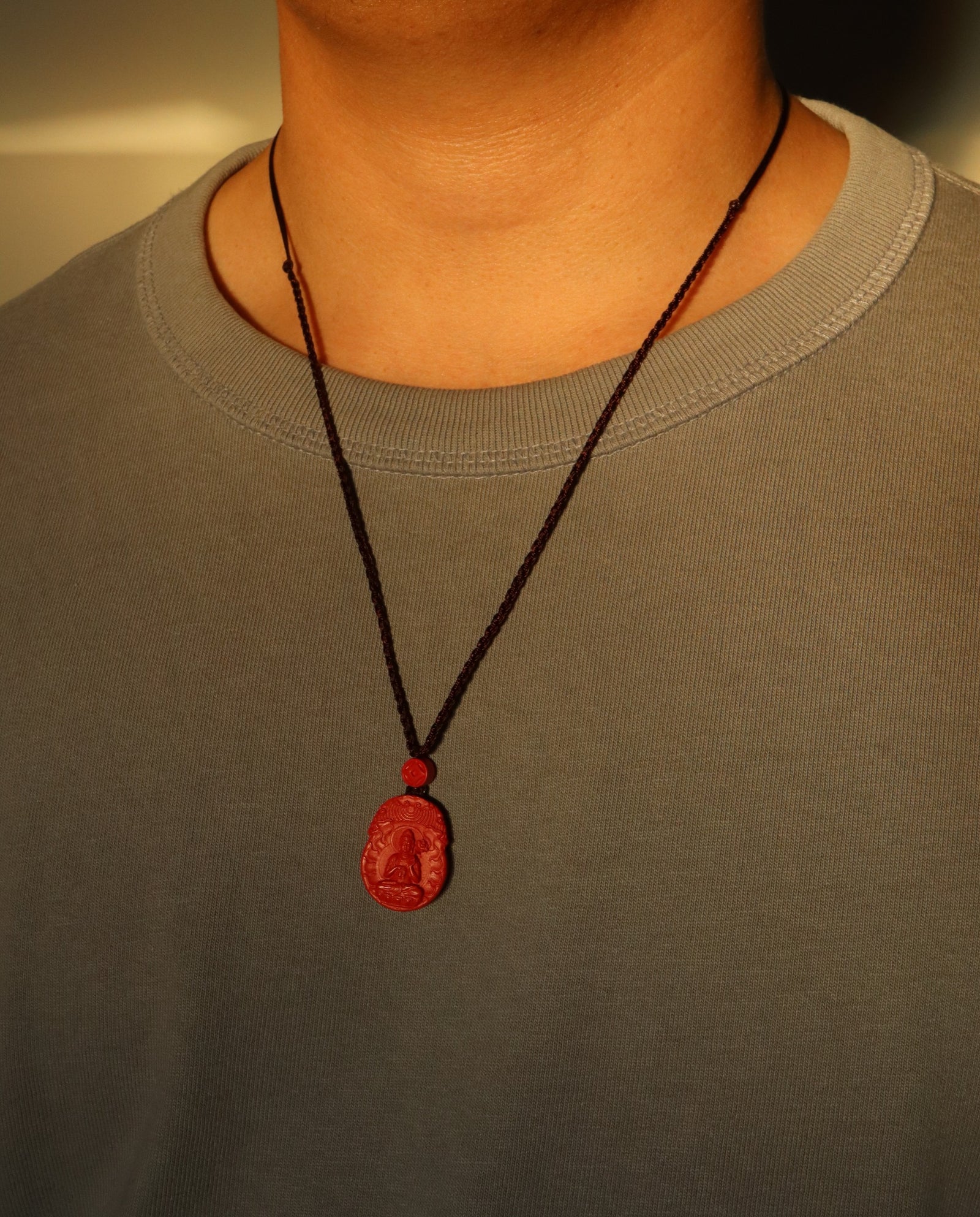 Horse Guardian cinnabar necklace on dark background