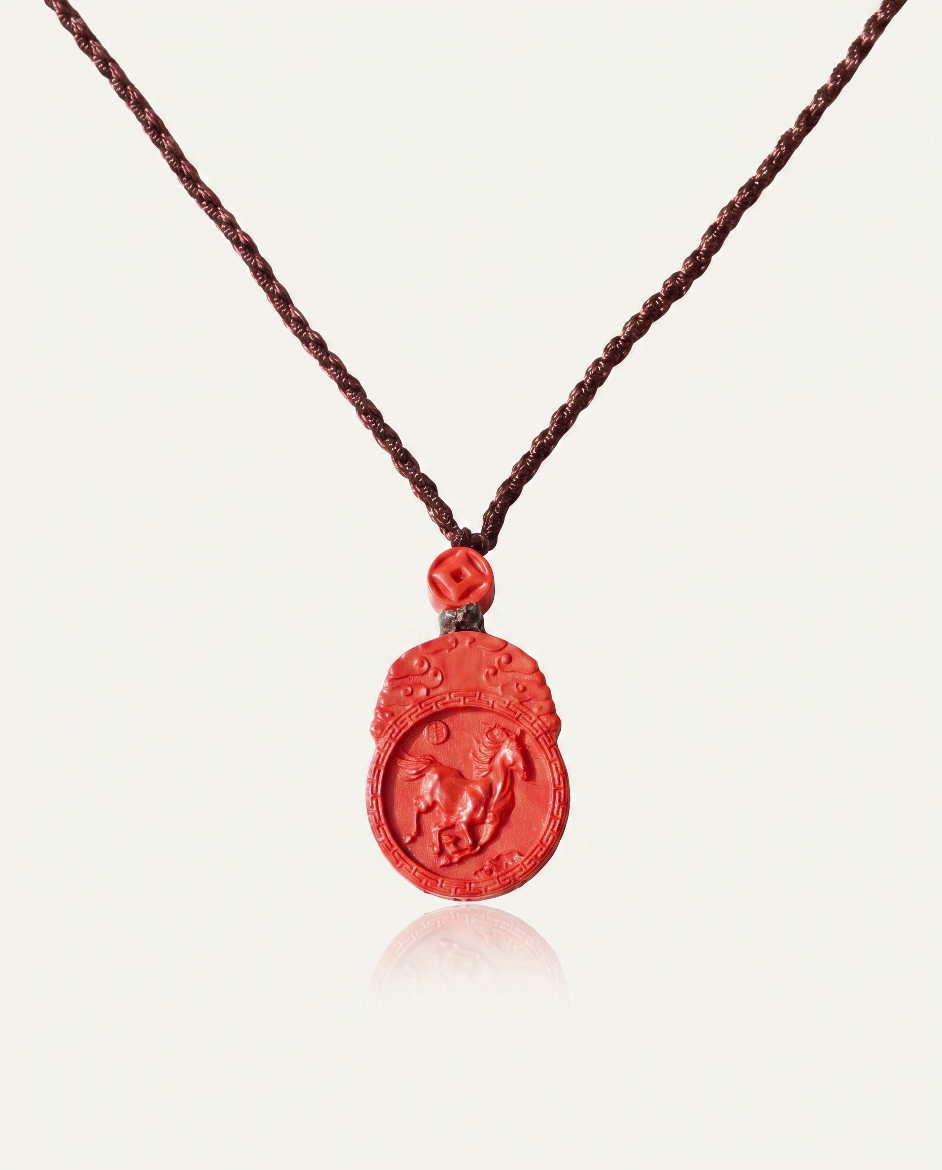 Horse Guardian cinnabar necklace on ivory studio background
