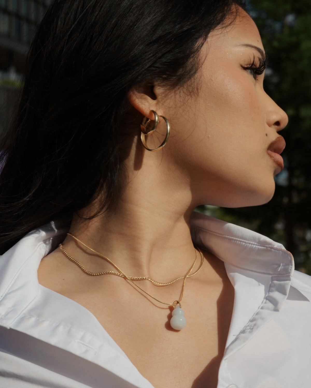 Jade hulu gourd necklace worn by model