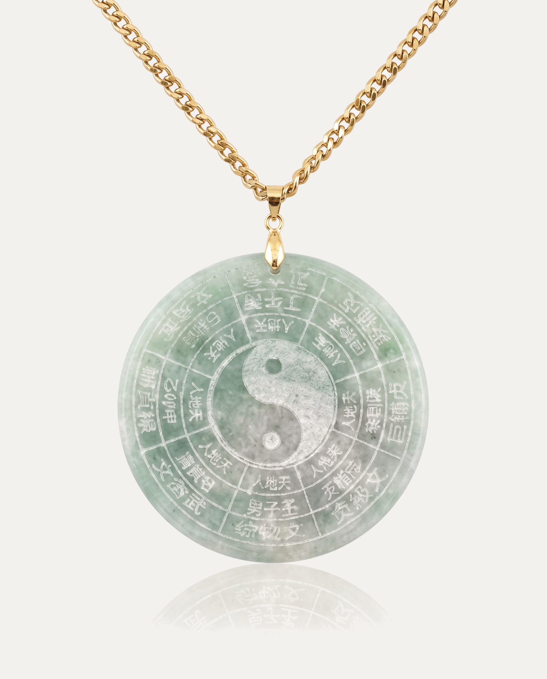 Jade Yin Yang Bagua Necklace with gold chain on ivory background