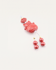 Lucky Cat Cinnabar Hanging Charm, studio photo
