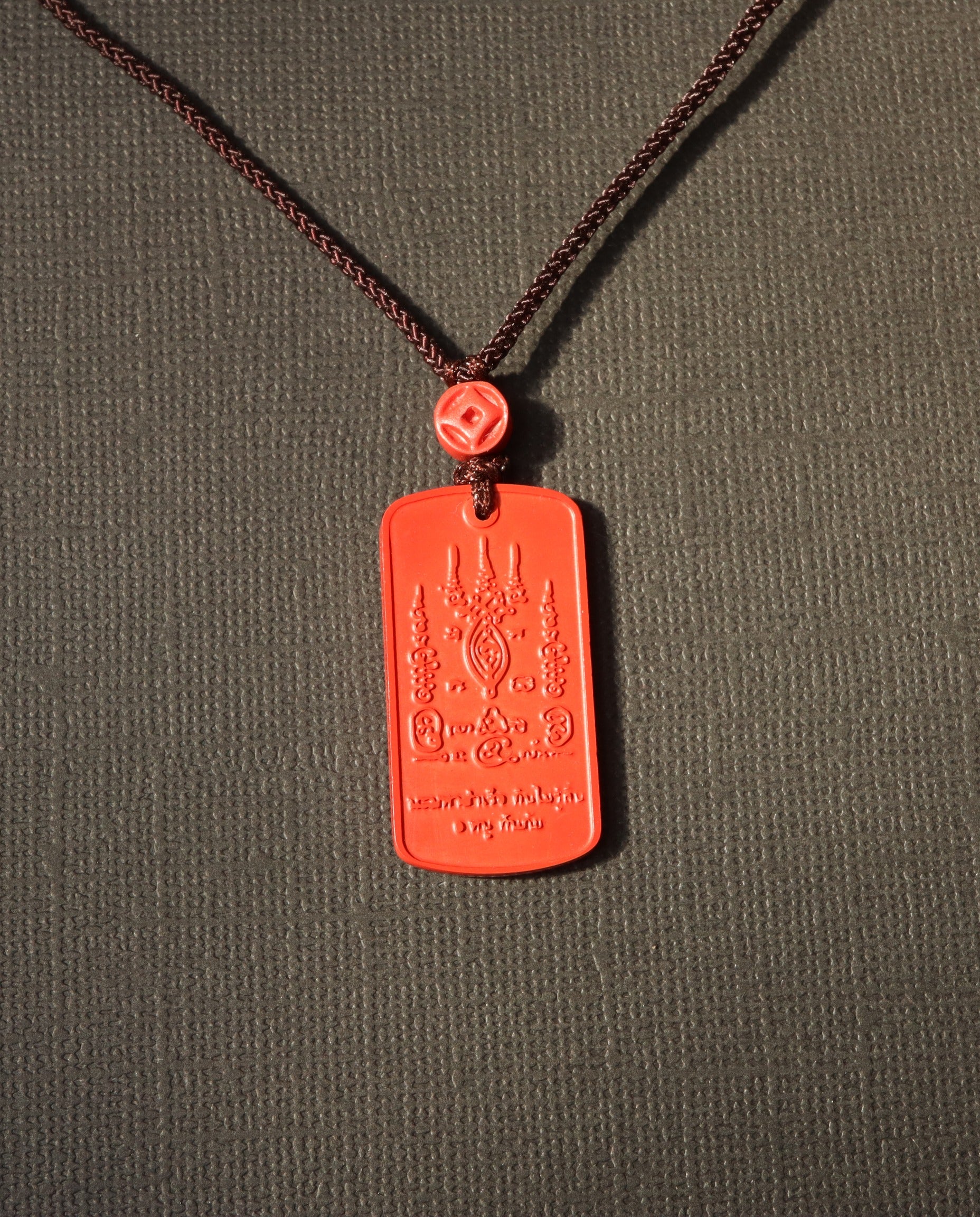 Mantra Protection Amulet cinnabar necklace on dark background