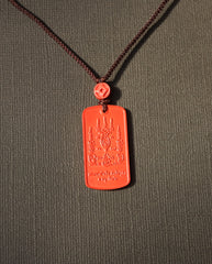 Mantra Protection Amulet cinnabar necklace on dark background