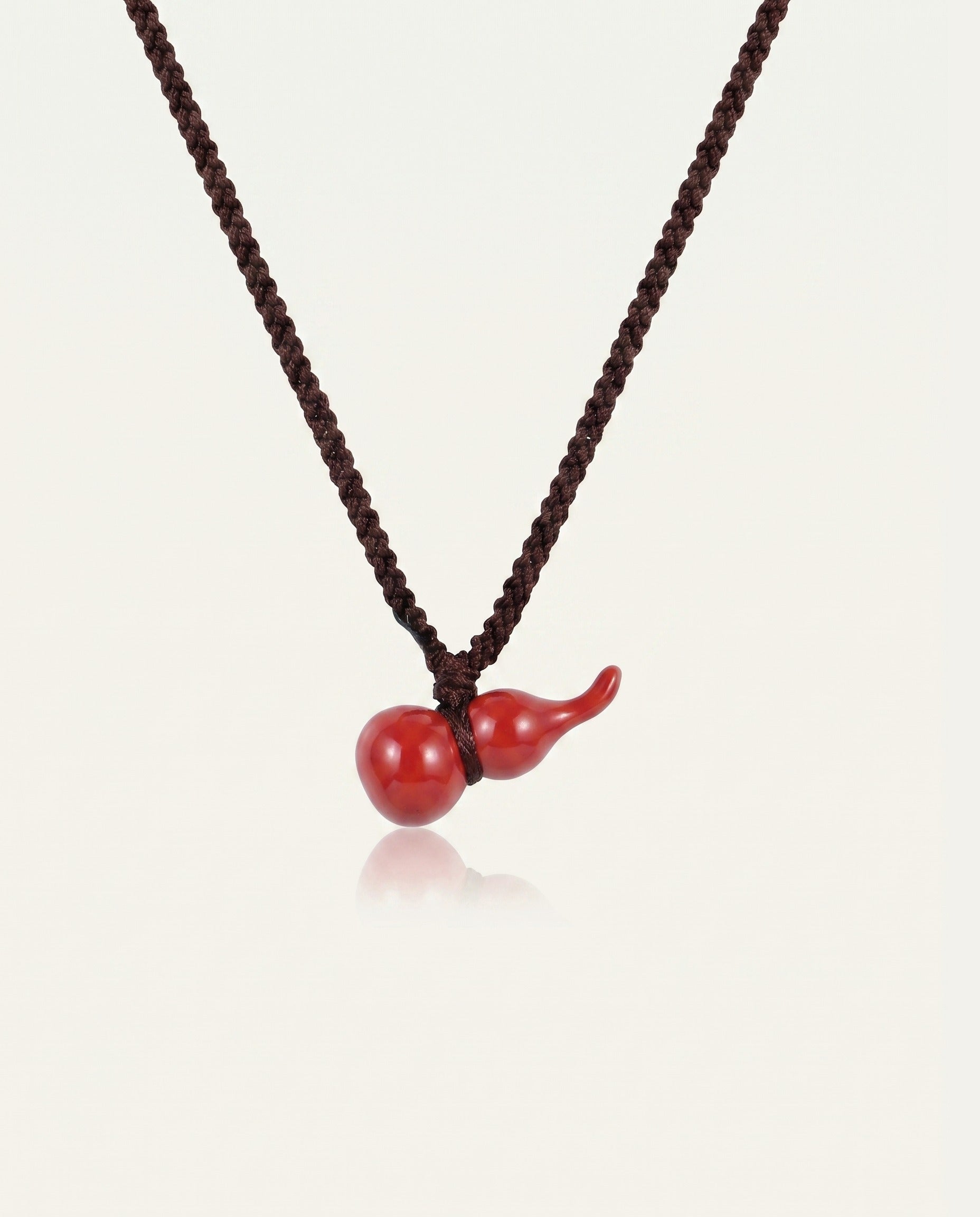 Mini Hulu cinnabar necklace on ivory studio background